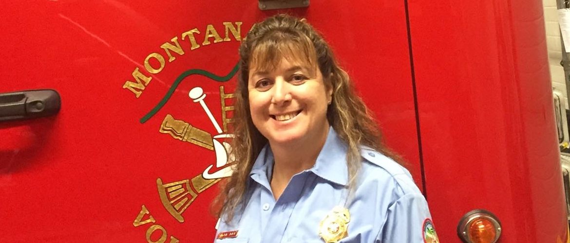 BCBSMT Volunteer of the Year Julie Rader poses with a fire truck.